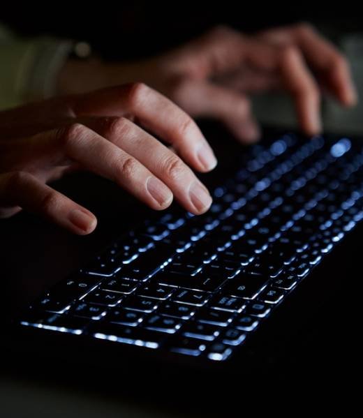 Hands,Of,Anonymous,Person,Typing,On,Laptop,Keyboard,At,Night, Hands